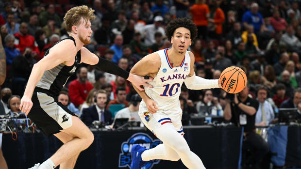 Mar 25, 2022; Chicago, IL, USA; Kansas Jayhawks forward Jalen Wilson (10) dribbles against Providence Friars forward Noah Horchler (14) during the first half in the semifinals of the Midwest regional of the men's college basketball NCAA Tournament at United Center. Mandatory Credit: Jamie Sabau-USA TODAY Sports